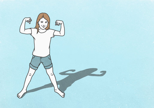 Portrait confident girl flexing biceps muscles on blue background