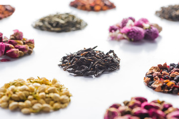 set of dried herbal healthy tea on white surface