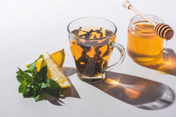 healthy tea with lemon and mint on white tabletop