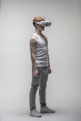 Young man using virtual reality simulator glasses