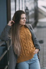 Young woman leaning against railing, looking away