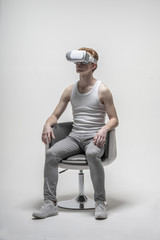 Young man using virtual reality simulator glasses