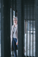 Portrait confident young woman behind gate