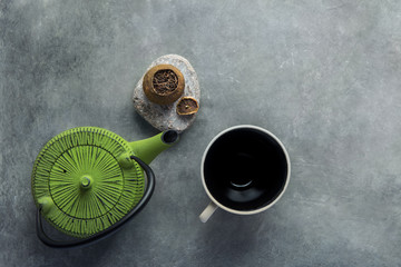 Aged Fermented Pu-erh Tea in Citrus Peel Green Kettle Empty Cup on Dark Stone Background. Chinese Japanese Asian Cuisine. Healthy Drinks Detox Antioxidants Concept. Vintage Minimalist Flat Lay