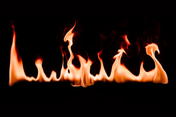 close up view of burning fire on black background