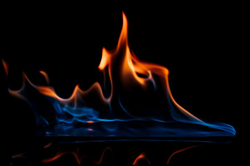 close up view of burning orange and blue flame on black background © LIGHTFIELD STUDIOS