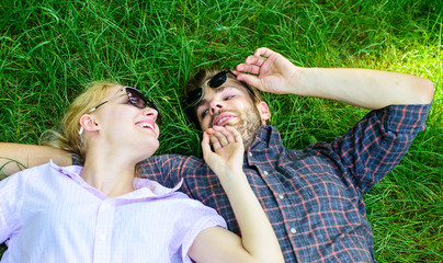 Closer to nature. Couple in love united with nature. Nature fills them with freshness and inspiration. Man unshaven and girl lay on grass meadow. Guy and girl happy carefree enjoy freshness of grass