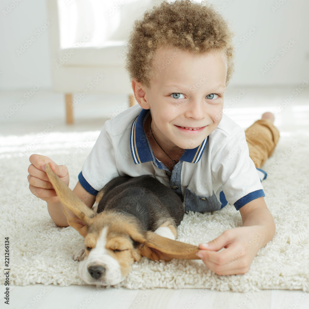 Wall mural Child with a dog 