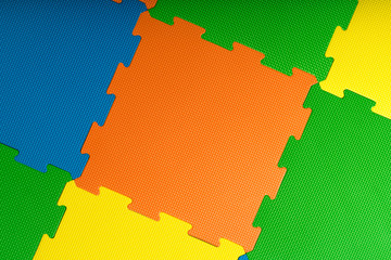 Protective foam floor tiles / mats inside a children's play room, kindergarten or gym. Potential use as a colorful background with copy space.