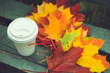 Coffee with fallen autumn leaves