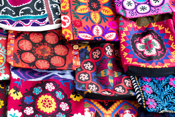 Market stalls with decorative tribal textile with colourful pattern made in Central Asia, Uzbekistan.