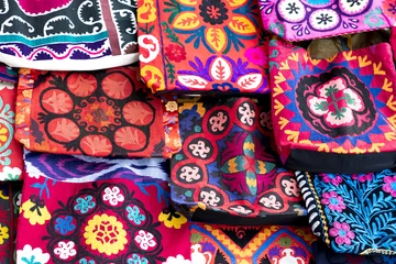 Gordijnen Market stalls with decorative tribal textile with colourful pattern made in Central Asia, Uzbekistan. © Curioso.Photography