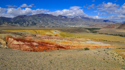 View of unrealy beautiful colorful clay cliffs in Kyzyl-Chin (Kisil-Chin) valley, Altai mountains, Russia. Summer landscape, which is called Martian for its fantastic lifeless beauty