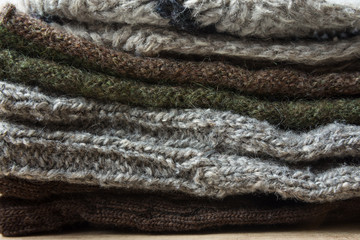 Stack of Handmade Warm Knitted Socks Scarfs Mittens From Rough Wool Yarn Brown Beige Grey. Close up. Winter Autumn Eco Fashion Kinfolk Style. Natural Materials Texture
