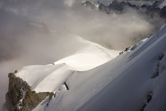 Mont Blanc mountaineers walking on snowy ridge. The mountain is the highest in the alps and the European Union.