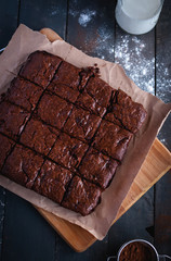 Homemade chocolate brownies on cutting board, top view