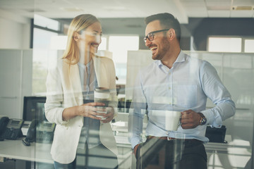 Obraz premium Business people standing in office and having break , time for coffee.