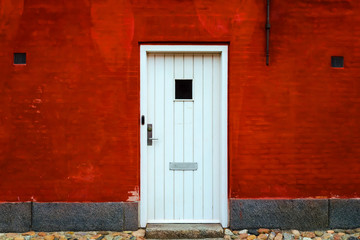 Old beautiful door against the red brick wall. Architecture.