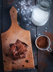 Homemade chocolate brownies on cutting board, top view