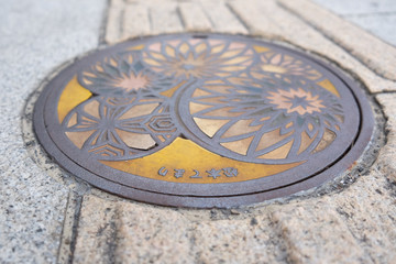 Yellow Designed Manhole Cover with Temari Handball Craft Matsumoto Japan