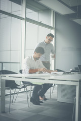 Two business men working together in office.