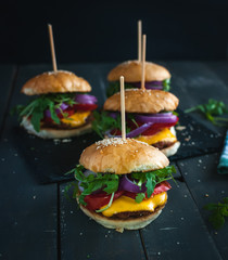 Homemade fresh burgers on dark background