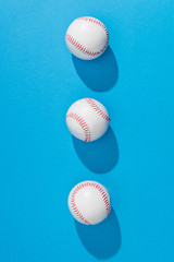 top view of arranged baseball balls on blue background