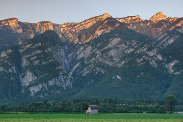 Farmhouse with alpenglow on the mountains
