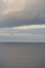 Blurred sunshine reflections in ocean and clouds over Canary Islands.