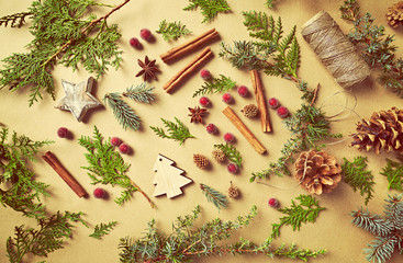 Fototapeta na wymiar Natural Christmas gift-wrap decorations on brown paper background. Flatlay