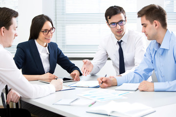 Businessman explains to colleagues a new project