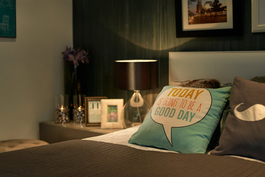 Cozy bedroom closeup shot, motivational quote on the pillow.