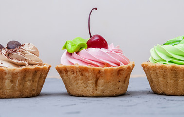 Cakes on grey stone background.

