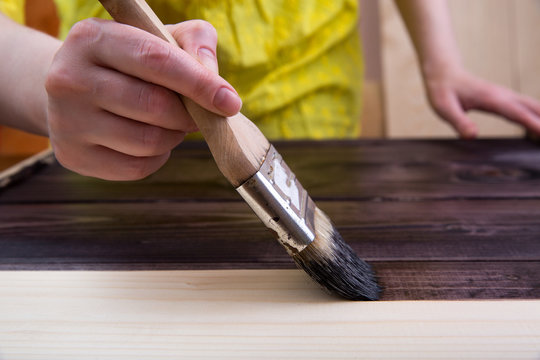 Tinting in the dark color of light wood with a brush.