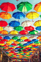 Fototapeta na wymiar Alley of soaring umbrellas on Salt Lane.