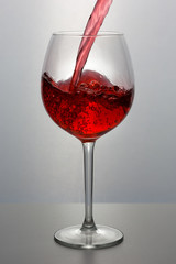 Beautiful splash of red wine in a glass