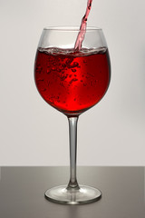 Beautiful splash of red wine in a glass