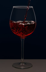 Beautiful splash of red wine in a glass