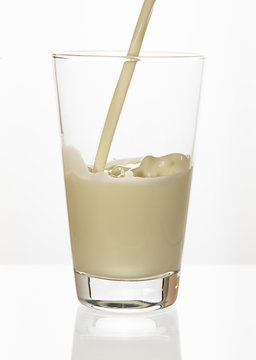 Fresh milk is poured into a glass.