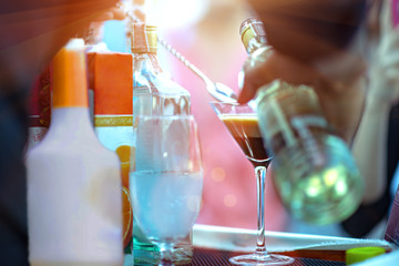 bottle of fruit cocktail pour into a cocktail glass by bartender for mixing make cocktail party funny enjoy and outdoor entertainment