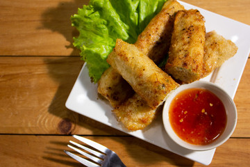 Fried spring rolls with chili sauce top view.