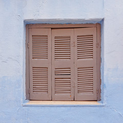 Greek island, brown window shutters and blue wall