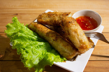 Fried spring rolls with chili sauce.