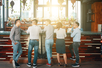 Office workers drinking beer at bar counter after working day © DragonImages