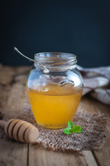 Close-up of honey in a jar on wooden background