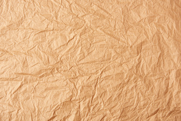 full frame of beige crumpled paper as background