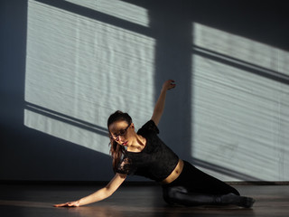 A young girl is engaged in jazz modern dance in the hall.