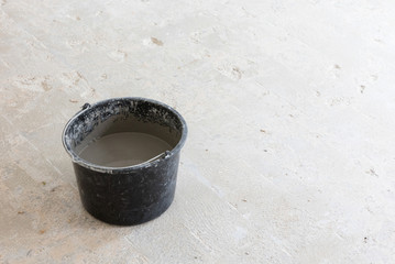 Mixed grey concrete and prime in the bucket