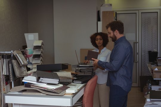 Architects discussing over wooden sample