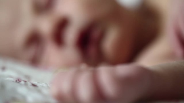 Newborn baby sleeps. Full-term newborn 2 weeks old baby boy lies on the bed and sleeps